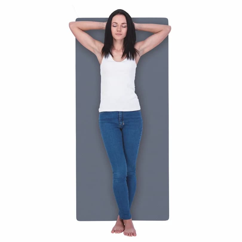 Woman lying relaxed on the grey Vissco full-body heating mat