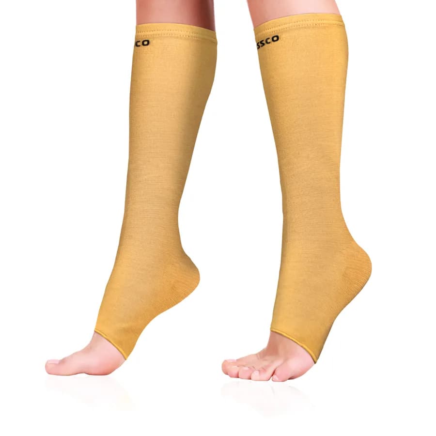 Vissco below-knee compression stocking in beige, worn on the lower leg, open toe